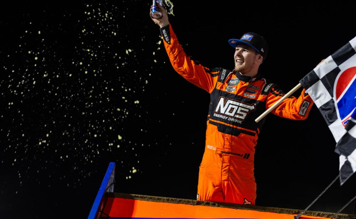 Sheldon Haudenschild celebrates atop the wing of his NOS Energy Drink #17